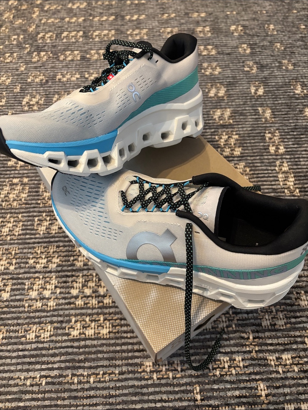 On Running Women's Athletic Shoes - Light Gray with Blue and Teal Accents.